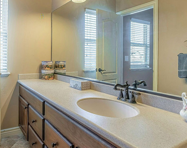 Granite stone countertop with dual sinks in Cedar Park, TX bathroom